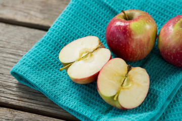 Close-up of red halved apples kept on cloth
