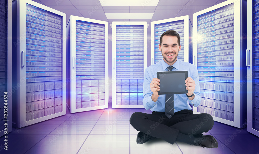 Canvas Prints Smiling businessman showing his digital tablet against digitally generated server room with towers