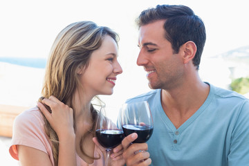 Loving young couple toasting wine glasses