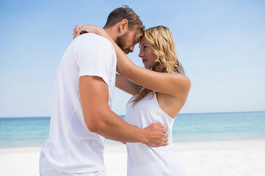 Side view of affectionate couple at beach