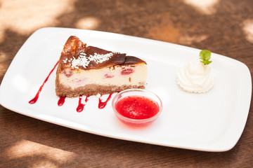 Cheesecake with chantilly cream and coulis