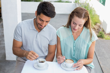Young couple with coffee cups at cafÃƒÂ©