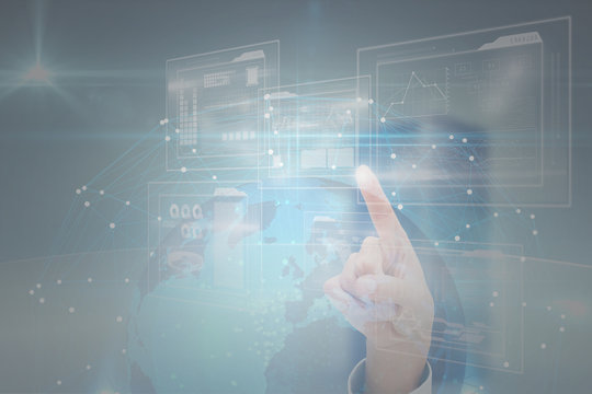 Hand pointing against globe in sphere on black background