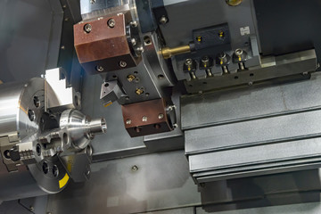 Fototapeta na wymiar The CNC turning or lathe machine cutting the thread at the end of metal cone shape part. High technology manufacturing process.