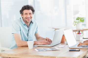 Casual business partners looking at laptop