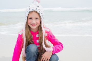 Fototapeta na wymiar Cute little girl in warm clothing at beach