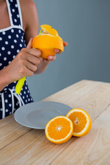 Woman peeling orange