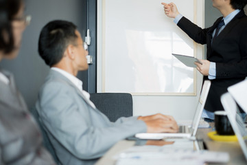 Business people present business ideas to the team while meeting in the office, business concept