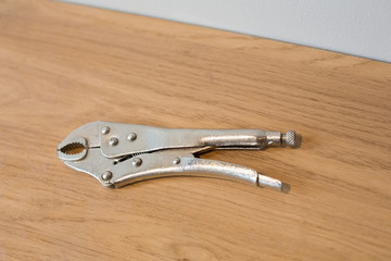 Pliers on wooden surface