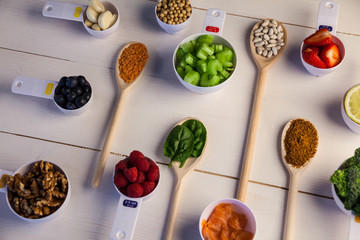 Naklejka premium Portion cups and spoons of healthy ingredients