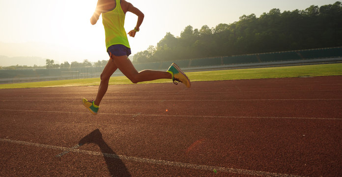 Fitness Sportswoman Running On Sunrise Track