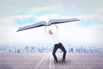 Businessman bending and pushing against city on the horizon