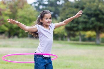 Obraz premium happy girl playing with hula hoops