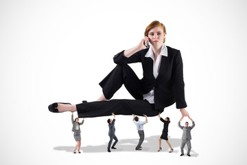 Business team supporting boss against white background