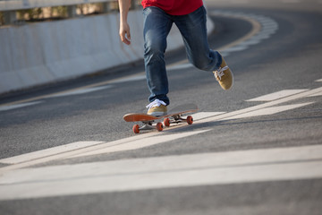 Fototapeta na wymiar Skateboarder sakteboarding on city highway