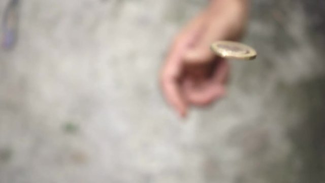 slowmotion shot tossing coin to flip on heads or tails