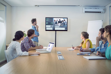 Business interface against attentive business team following a presentation