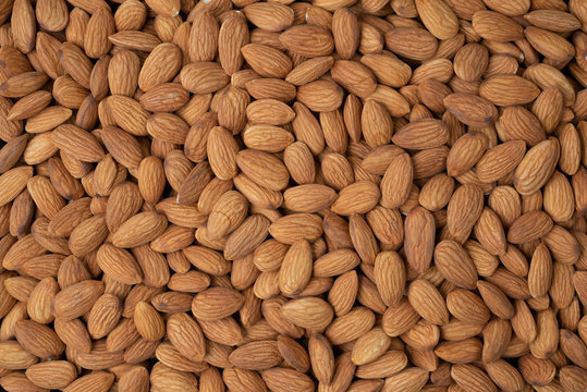 Almond nuts pile background. Roasted peeled almond nuts pile texture ,top view.