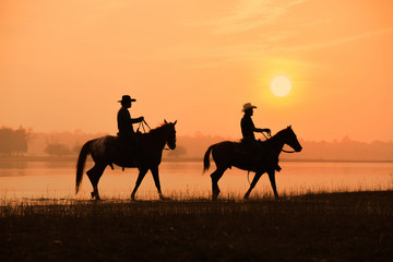 Fototapeta na wymiar cowboy and horse with sunset background