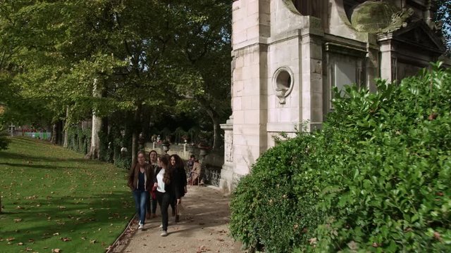 PARIS, FRANCE - SEPTEMBER 29, 2017: Timelapse shot of strolling in autumn Luxembourg Gardens. Walking on the path to the pond. Garden covering 23 hectares