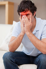 Desperate young man sitting on the sofa
