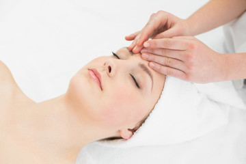 Obraz na płótnie Canvas Hands massaging a beautiful womans forehead