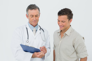 Doctor discussing reports with patient in office