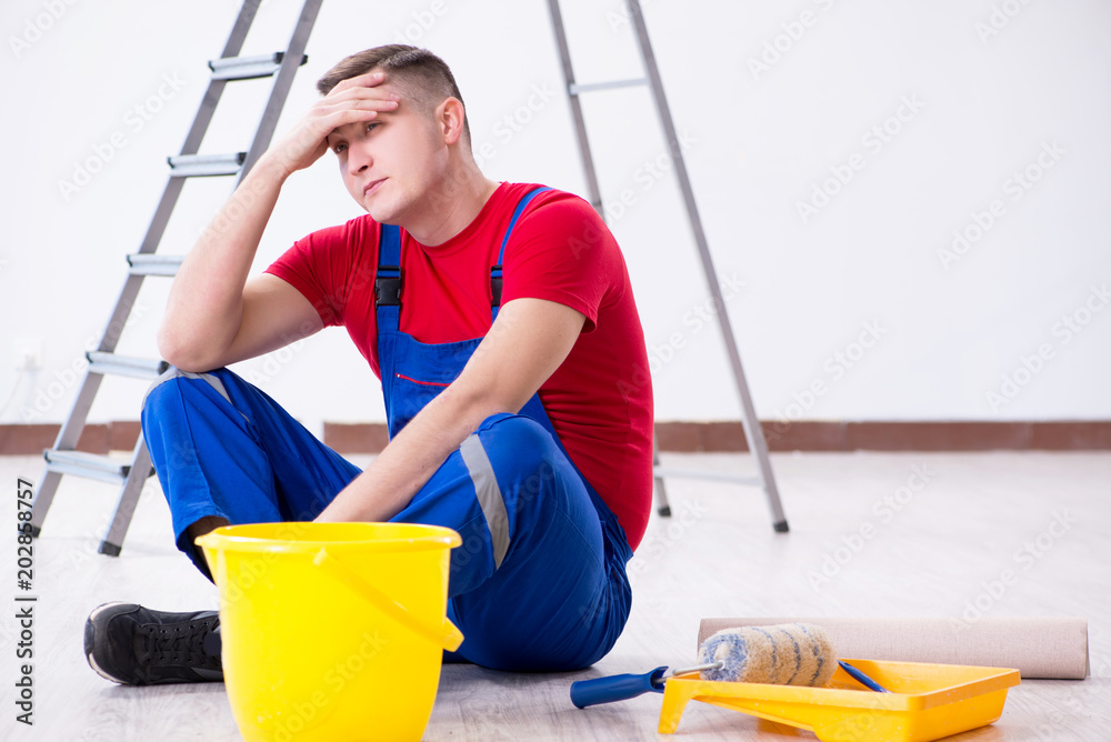 Wall mural Male painter preparing for painting job at construction site