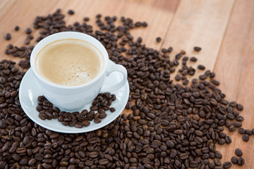 Cup of coffee with roasted coffee beans