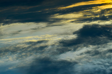 Sky and black clouds on the day of thunderstorms. Shines orange on the clouds