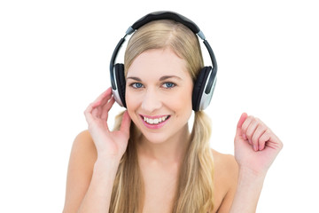 Fototapeta premium Pretty young blonde woman enjoying music