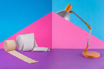 Abstract collage with table lamp and toilet paper on a colored background