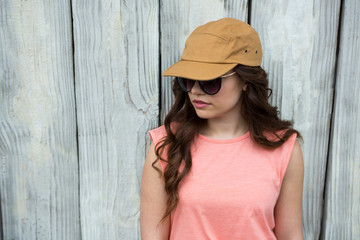 Woman in brown cap and sunglasses