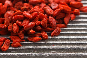 dried goji berries on a wooden rustic background
