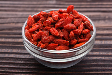 dried goji berries on a wooden rustic background