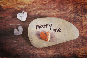 Heart shaped stones  on a wooden background