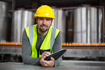Factory worker using digital tablet