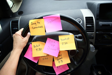 Steering wheel covered in notes as a reminder of errands to do