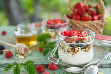 Healthy yogurt with granola and raspberry. Concept for healthy eating and nutrition.