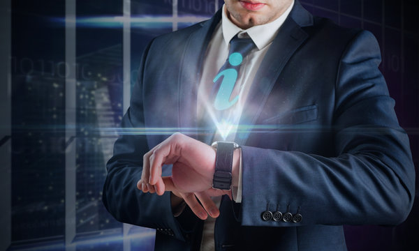 Composite image of businessman using hologram watch in office overlooking city