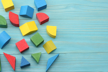 colorful wooden cubes on blue wooden background. Top view. Toys in the table