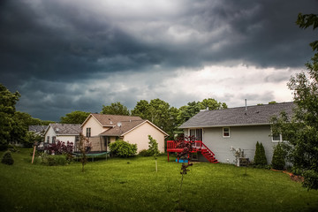 Thuderstorm clouds over suburban houses