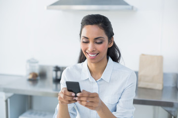 Content woman text messaging with her smartphone 