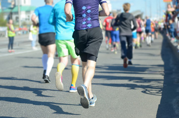 Marathon running race, many runners feet on road racing, sport competition, fitness and healthy lifestyle concept
