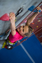 Obraz na płótnie Canvas Portrait of teenage girl practicing rock climbing