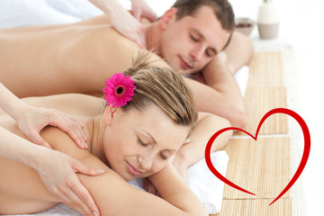 Obraz na płótnie Canvas Relaxing couple having a massage against heart