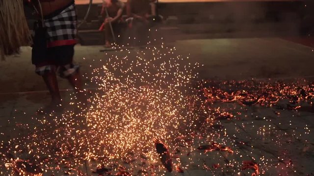 Bali, Indonesia Fabruary 3, 2018: Balinese Kecak Dance, known as the Ramayana Monkey Chant and Fire Dance at temple in Ubud Village on Bali, Indonesia. Old an walks with his bare feet on the coals