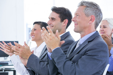 Business team applauding during conference 