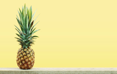 Pineapple with yellow background.