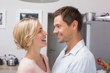 Loving couple looking at each other in the kitchen